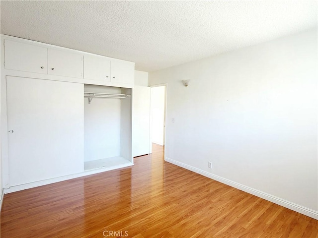 2616 Gates Ave, Redondo Beach, CA 90278 - unfurnished bedroom with light wood-style floors, a closet, baseboards, and a textured ceiling