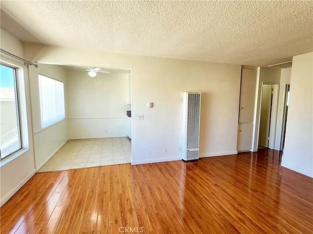 2616 Gates Ave, Redondo Beach, CA 90278 - unfurnished room with a heating unit, wood finished floors, a textured ceiling, ceiling fan, and baseboards