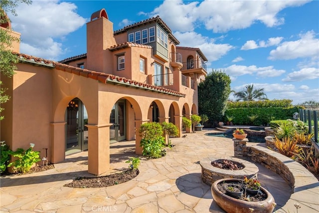 7 Ocean Heights Dr, Newport Coast, CA 92657 - back of house with a chimney, a patio area, stucco siding, an outdoor fire pit, and a tile roof
