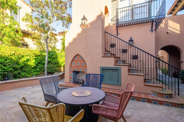 7 Ocean Heights Dr, Newport Coast, CA 92657 - view of patio featuring a fireplace, stairway, and outdoor dining area