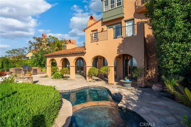 7 Ocean Heights Dr, Newport Coast, CA 92657 - back of property with a balcony, stucco siding, a patio area, exterior kitchen, and a chimney