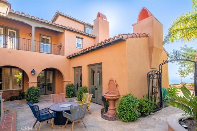 7 Ocean Heights Dr, Newport Coast, CA 92657 - view of patio with french doors, a balcony, and a gate