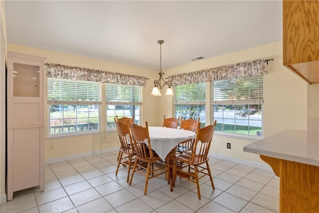 156 Greenfield Dr, Chico, CA 95973 - dining area featuring light tile patterned floors, baseboards, plenty of natural light, and a chandelier