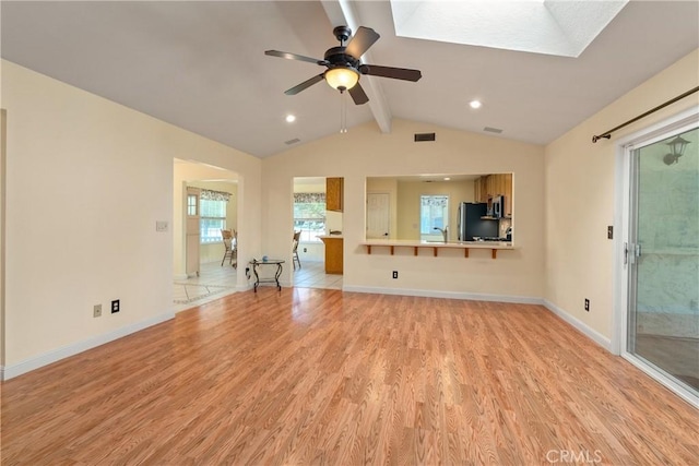 156 Greenfield Dr, Chico, CA 95973 - unfurnished living room featuring a ceiling fan, light wood finished floors, baseboards, a skylight, and recessed lighting