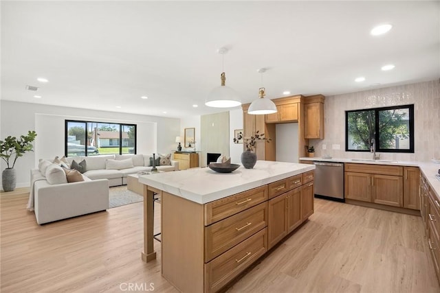 4732 Tucana St, Yorba Linda, CA 92886 - kitchen featuring stainless steel dishwasher, a sink, light wood finished floors, recessed lighting, and hanging light fixtures