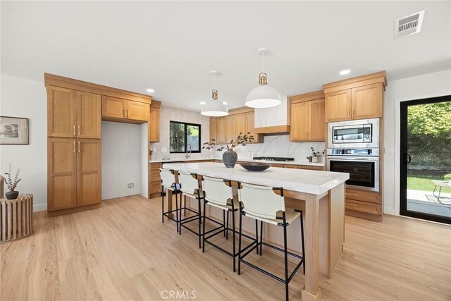 4732 Tucana St, Yorba Linda, CA 92886 - kitchen with stainless steel appliances, light countertops, light wood-style flooring, a center island, and recessed lighting