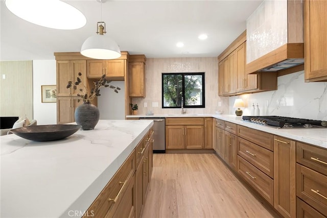 4732 Tucana St, Yorba Linda, CA 92886 - kitchen with appliances with stainless steel finishes, a sink, light wood finished floors, tasteful backsplash, and light stone counters