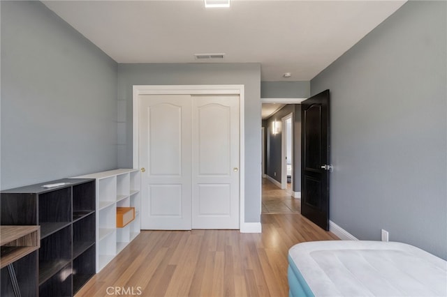 2505 Stuart Ave, Clovis, CA 93611 - unfurnished bedroom featuring light wood-type flooring, a closet, and baseboards