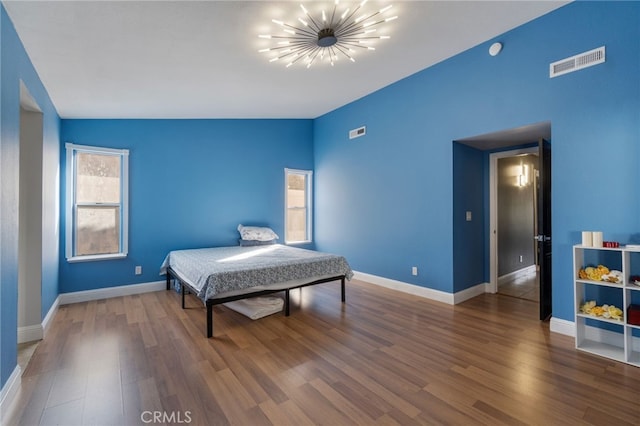 2505 Stuart Ave, Clovis, CA 93611 - bedroom with a chandelier, wood finished floors, and baseboards
