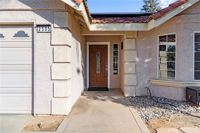 2505 Stuart Ave, Clovis, CA 93611 - entrance to property featuring a tile roof, stucco siding, and solar panels