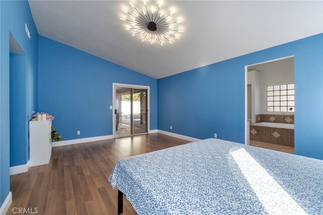 2505 Stuart Ave, Clovis, CA 93611 - bedroom with a chandelier, access to exterior, wood finished floors, vaulted ceiling, and baseboards