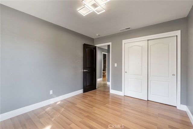 2505 Stuart Ave, Clovis, CA 93611 - unfurnished bedroom with baseboards, light wood finished floors, and a closet