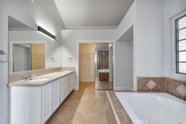 2505 Stuart Ave, Clovis, CA 93611 - bathroom with a bath, double vanity, a spacious closet, and tile patterned floors