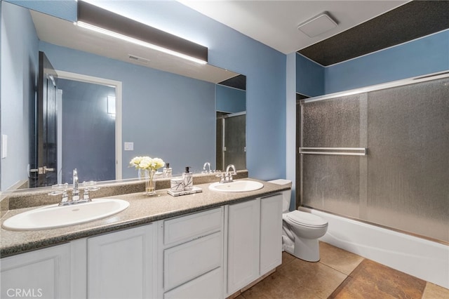 2505 Stuart Ave, Clovis, CA 93611 - bathroom with tile patterned floors, double vanity, toilet, and shower / bath combination with glass door