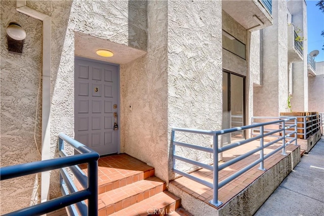 11954 Mayfield Ave Unit 3, Los Angeles, CA 90049 - doorway to property featuring stucco siding