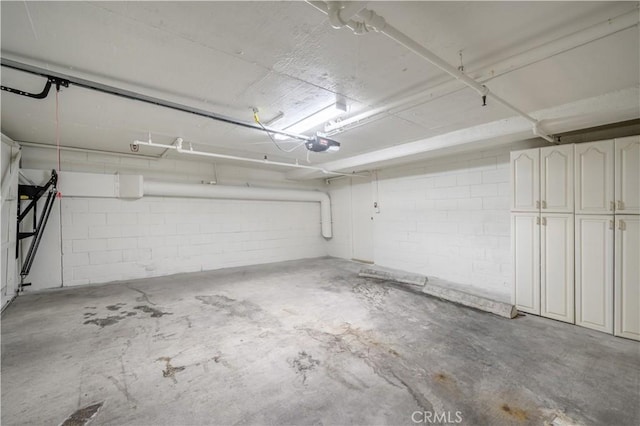 11954 Mayfield Ave Unit 3, Los Angeles, CA 90049 - garage featuring a garage door opener and concrete block wall
