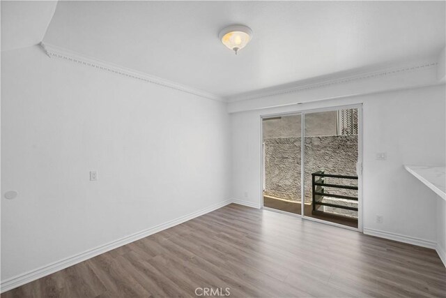 11954 Mayfield Ave Unit 3, Los Angeles, CA 90049 - spare room with wood finished floors, ornamental molding, and baseboards