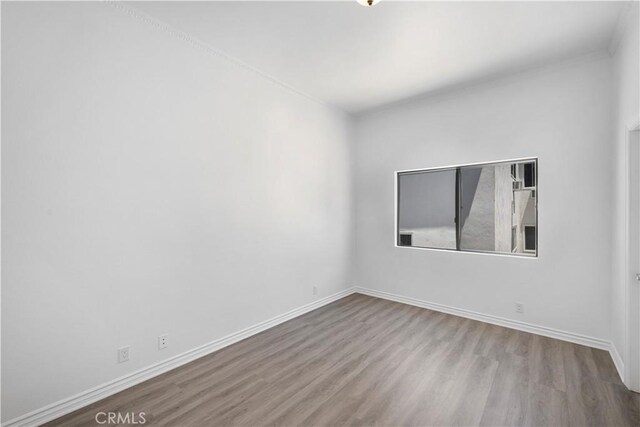 11954 Mayfield Ave Unit 3, Los Angeles, CA 90049 - empty room with wood finished floors and baseboards