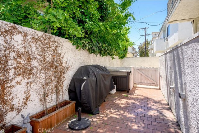 11954 Mayfield Ave Unit 3, Los Angeles, CA 90049 - view of patio / terrace with grilling area, a gate, and fence