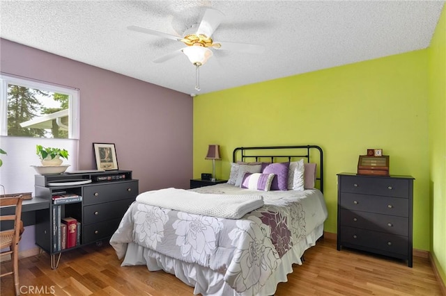 788 Marcia Ct, Chico, CA 95973 - bedroom with wood finished floors, a textured ceiling, and a ceiling fan