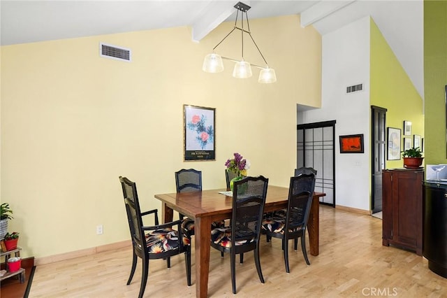 788 Marcia Ct, Chico, CA 95973 - dining room featuring light wood finished floors, beam ceiling, high vaulted ceiling, and baseboards