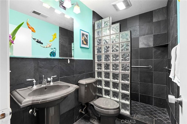 788 Marcia Ct, Chico, CA 95973 - bathroom featuring tile walls, walk in shower, toilet, and a sink