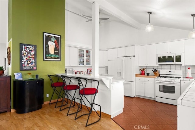 788 Marcia Ct, Chico, CA 95973 - kitchen with white appliances, high vaulted ceiling, a peninsula, ornate columns, and a kitchen breakfast bar
