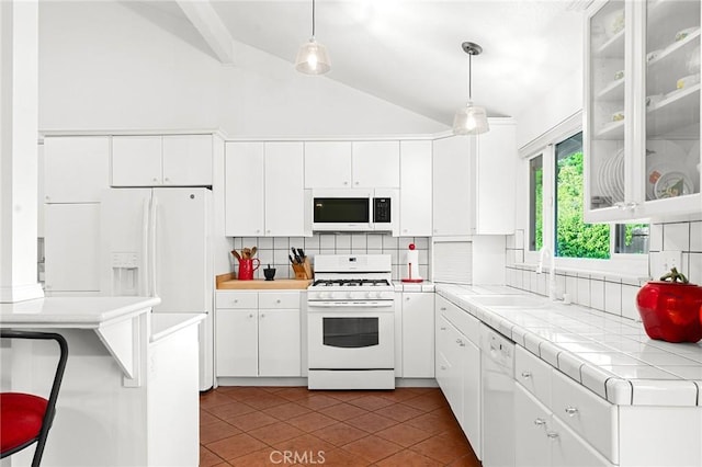 788 Marcia Ct, Chico, CA 95973 - kitchen with white appliances, lofted ceiling, tasteful backsplash, dark tile patterned floors, and white cabinetry