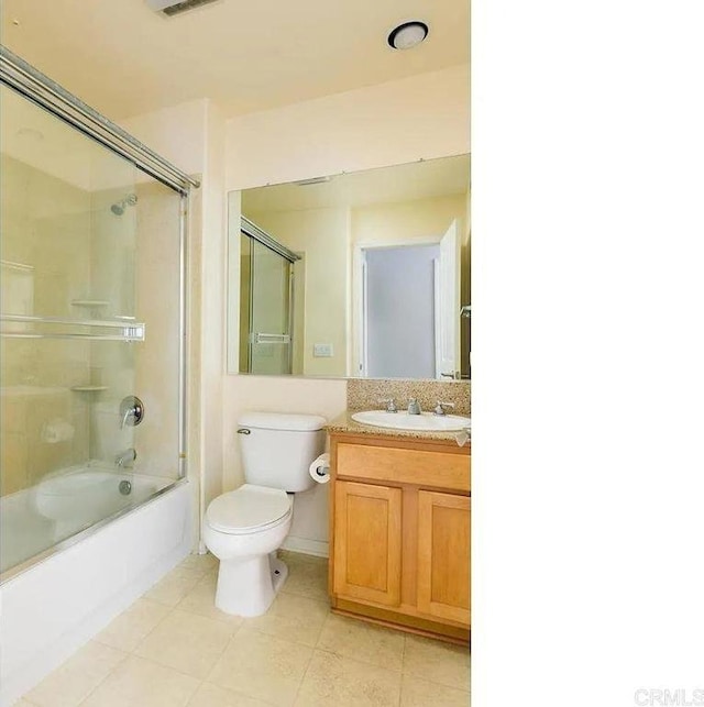 full bath with washtub / shower combination, toilet, tile patterned flooring, and vanity
