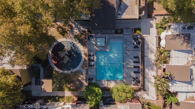 aerial view of property and surrounding area featuring a pool area