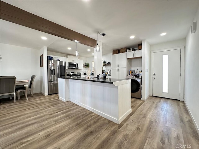 309 Santo Dr, San Jacinto, CA 92583 - kitchen featuring appliances with stainless steel finishes, washer / clothes dryer, light wood-style floors, white cabinets, and dark countertops