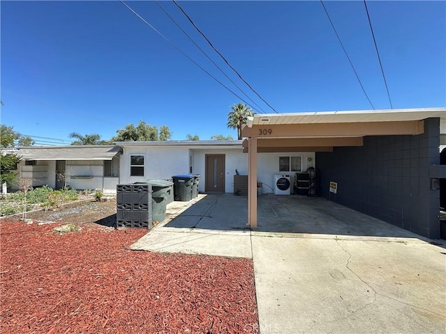 309 Santo Dr, San Jacinto, CA 92583 - view of front of property featuring an attached carport, driveway, and washer / dryer