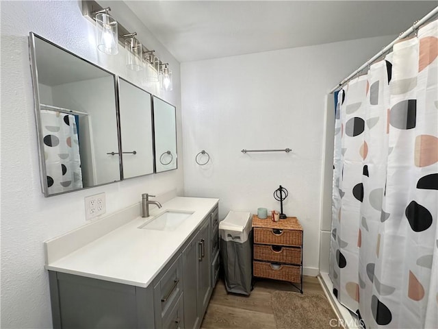 309 Santo Dr, San Jacinto, CA 92583 - full bath with wood finished floors, vanity, and a shower with shower curtain