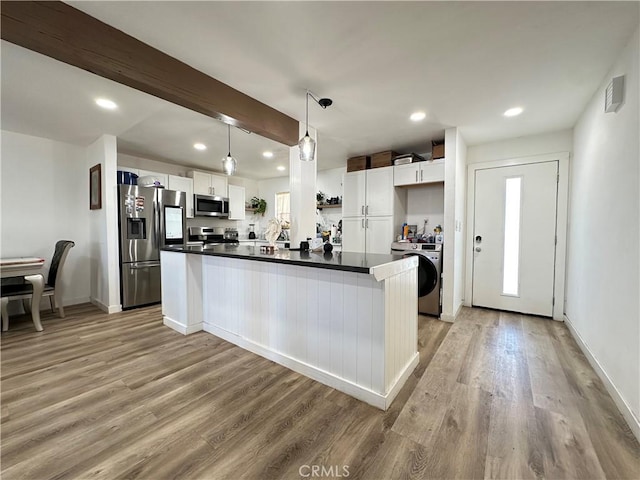 309 Santo Dr, San Jacinto, CA 92583 - kitchen with appliances with stainless steel finishes, washer / dryer, light wood-style floors, dark countertops, and recessed lighting