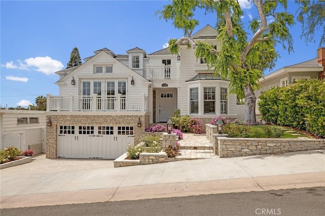 2711 Elm Ave, Manhattan Beach, CA 90266 - view of front of property featuring a balcony, an attached garage, driveway, and stone siding