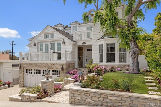 2711 Elm Ave, Manhattan Beach, CA 90266 - view of front facade featuring a balcony, a garage, stone siding, driveway, and a front yard