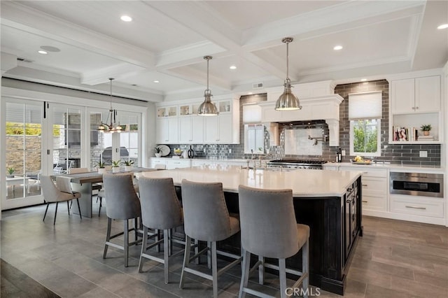 2711 Elm Ave, Manhattan Beach, CA 90266 - kitchen with light countertops, decorative backsplash, a large island, a kitchen bar, and beamed ceiling