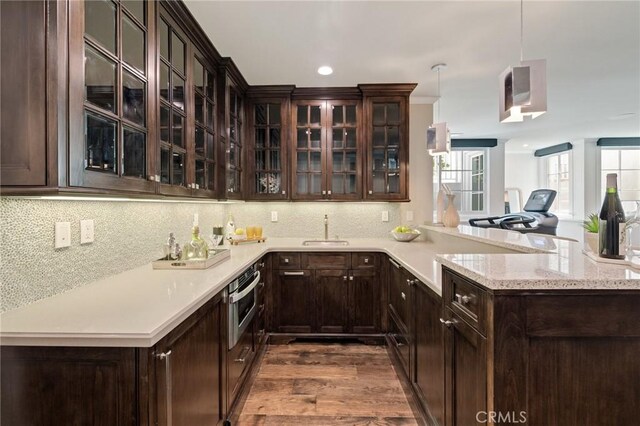 2711 Elm Ave, Manhattan Beach, CA 90266 - kitchen featuring oven, a sink, dark brown cabinetry, dark wood finished floors, and recessed lighting