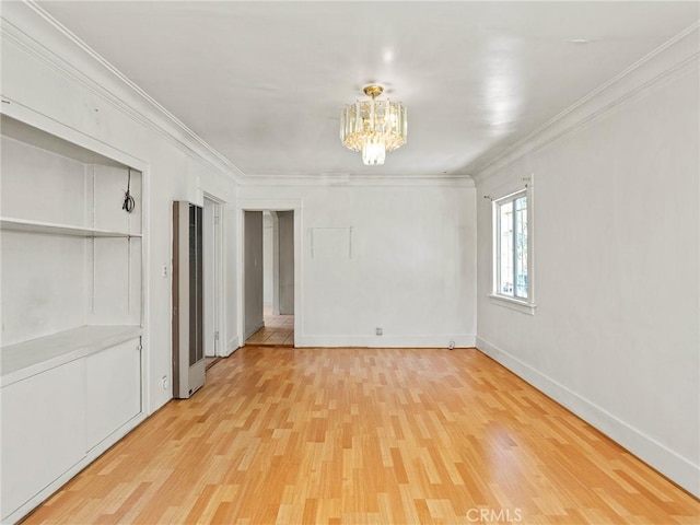 911 N Dos Robles Pl, Alhambra, CA 91801 - spare room featuring a heating unit, a chandelier, light wood finished floors, crown molding, and baseboards