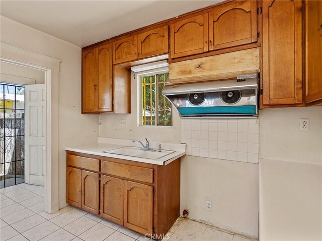 911 N Dos Robles Pl, Alhambra, CA 91801 - kitchen featuring a sink, brown cabinets, light countertops, and plenty of natural light