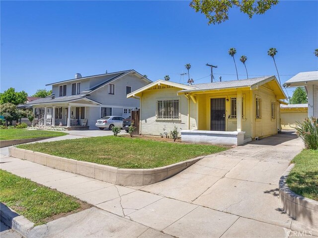 911 N Dos Robles Pl, Alhambra, CA 91801 - back of property featuring covered porch and a lawn