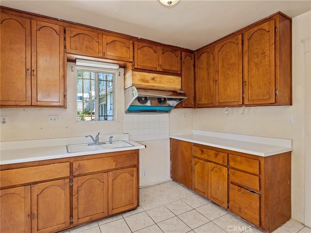 911 N Dos Robles Pl, Alhambra, CA 91801 - kitchen featuring a sink, brown cabinets, and light countertops