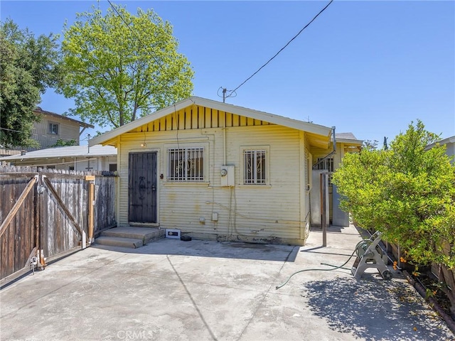 911 N Dos Robles Pl, Alhambra, CA 91801 - rear view of property with fence, a patio, and board and batten siding
