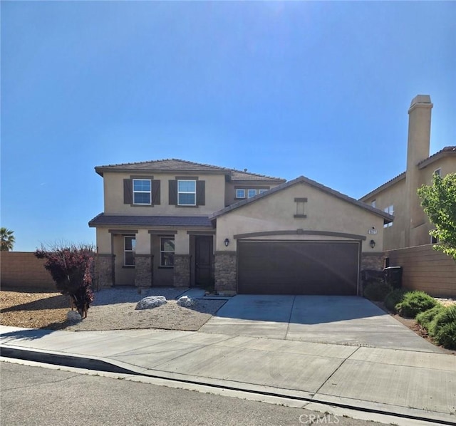15177 Paseo Verde Pl, Victorville, CA 92394 - traditional-style home featuring stucco siding, a garage, concrete driveway, and stone siding