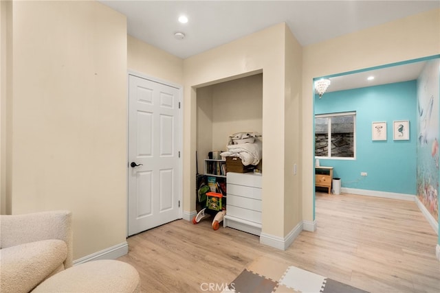 sitting room with light wood finished floors, baseboards, and recessed lighting
