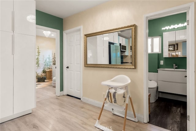 hall with wood finished floors and baseboards