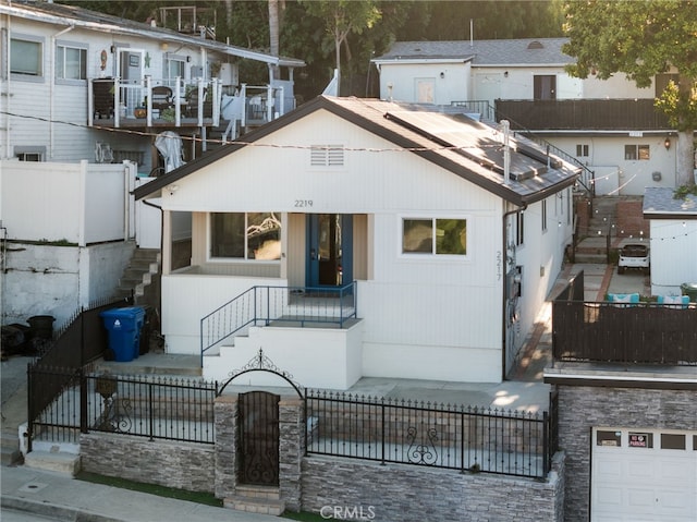 view of front of house with a fenced front yard and stairs