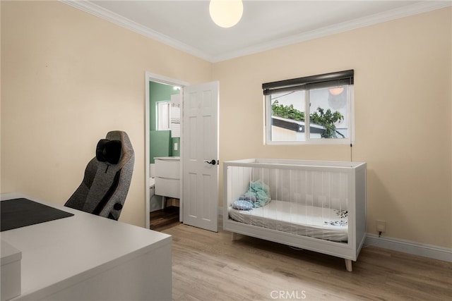 bedroom with wood finished floors, ornamental molding, a desk, and baseboards