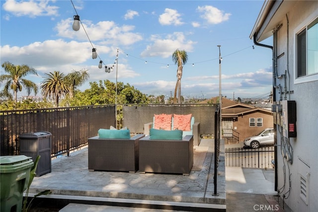 view of patio / terrace featuring an outdoor living space and fence