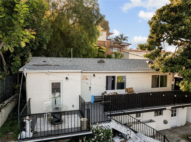 2217 S Gaffey St, San Pedro, CA 90731 - view of front of house featuring stairway, stucco siding, roof with shingles, and a patio